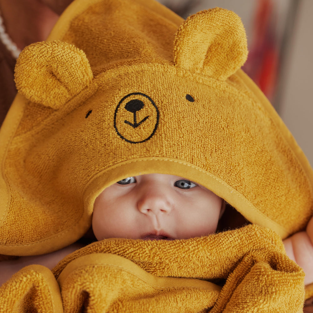 Close-up of plush fabric on the Huxie hooded towel highlights softness.