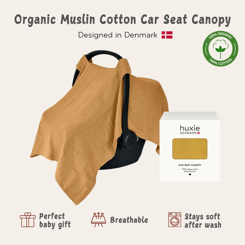 Huxie Denmark car seat canopy offers privacy while on the go in soft organic muslin.