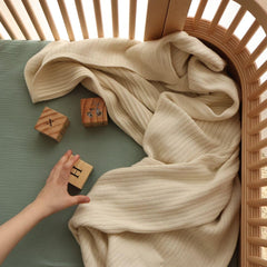 Huxie Knitted Baby Blanket 30x40 in crib providing breathable warmth