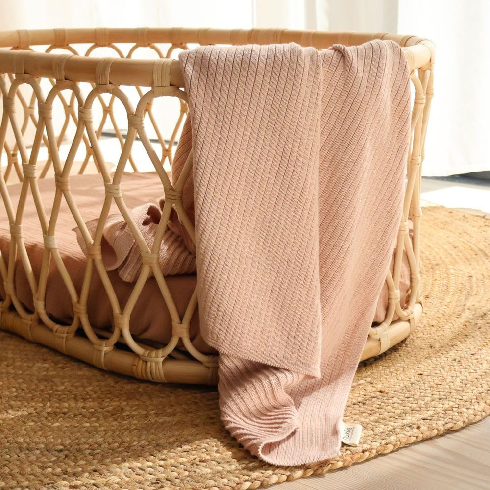 Huxie knitted baby blanket care shot demonstrates easy cold-wash maintenance that preserves softness.