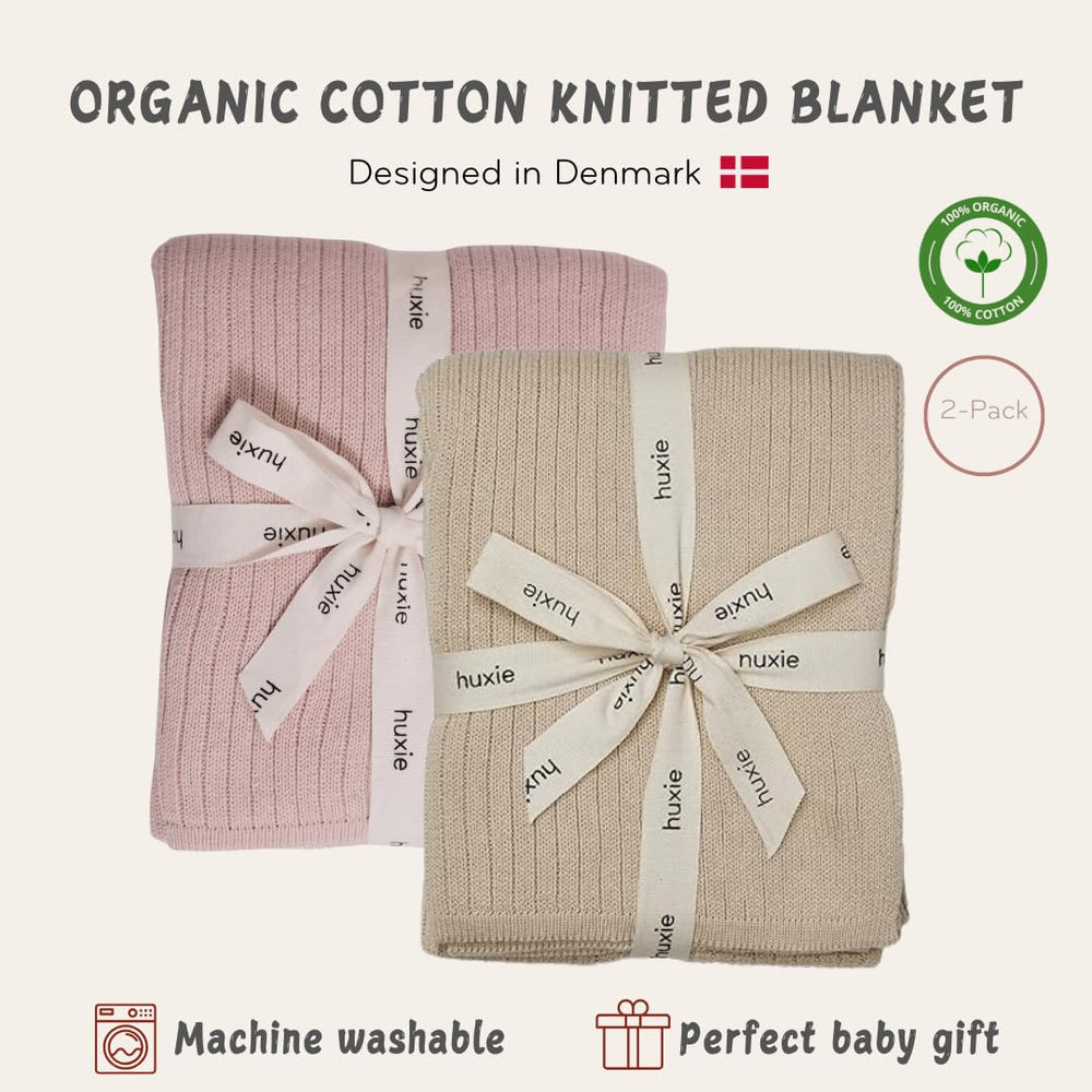 Huxie knitted baby blanket crib scene demonstrates generous 30x40 size for cuddling.