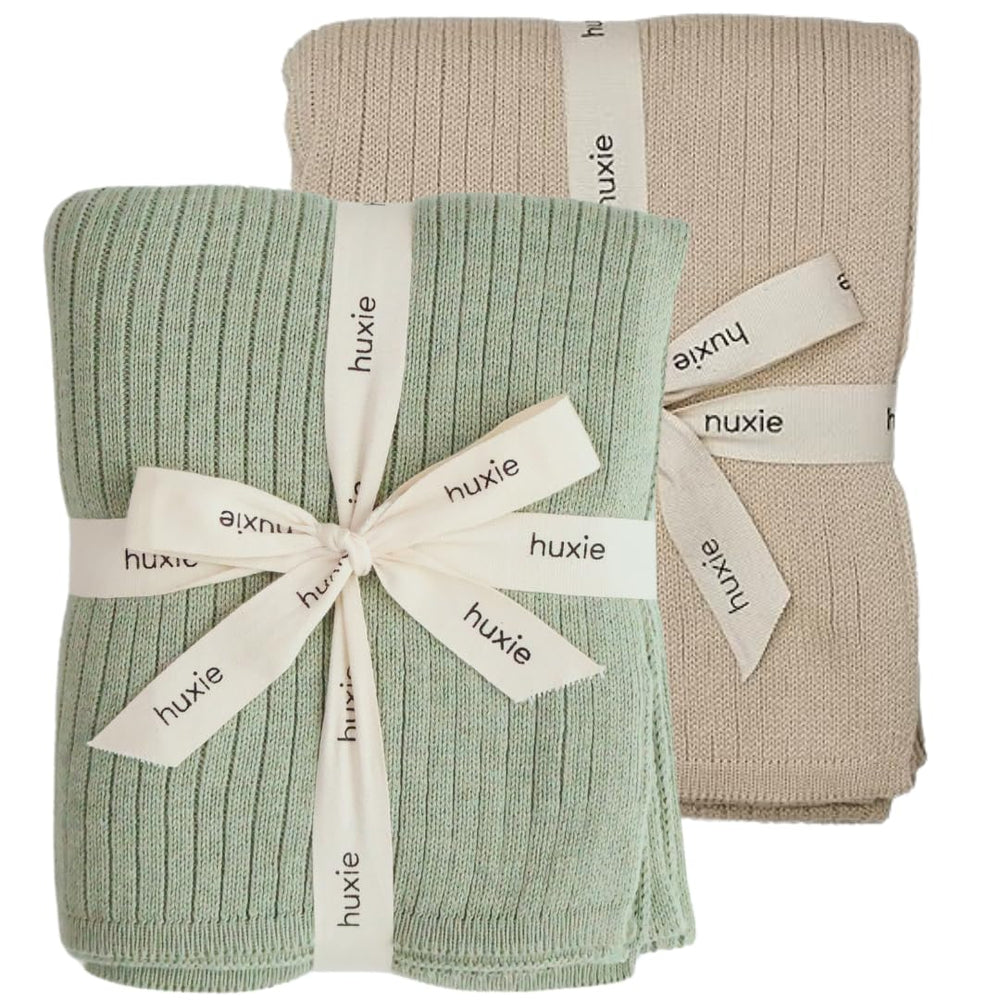Huxie knitted baby blanket Fog colorway offers cozy organic warmth for sensitive skin.