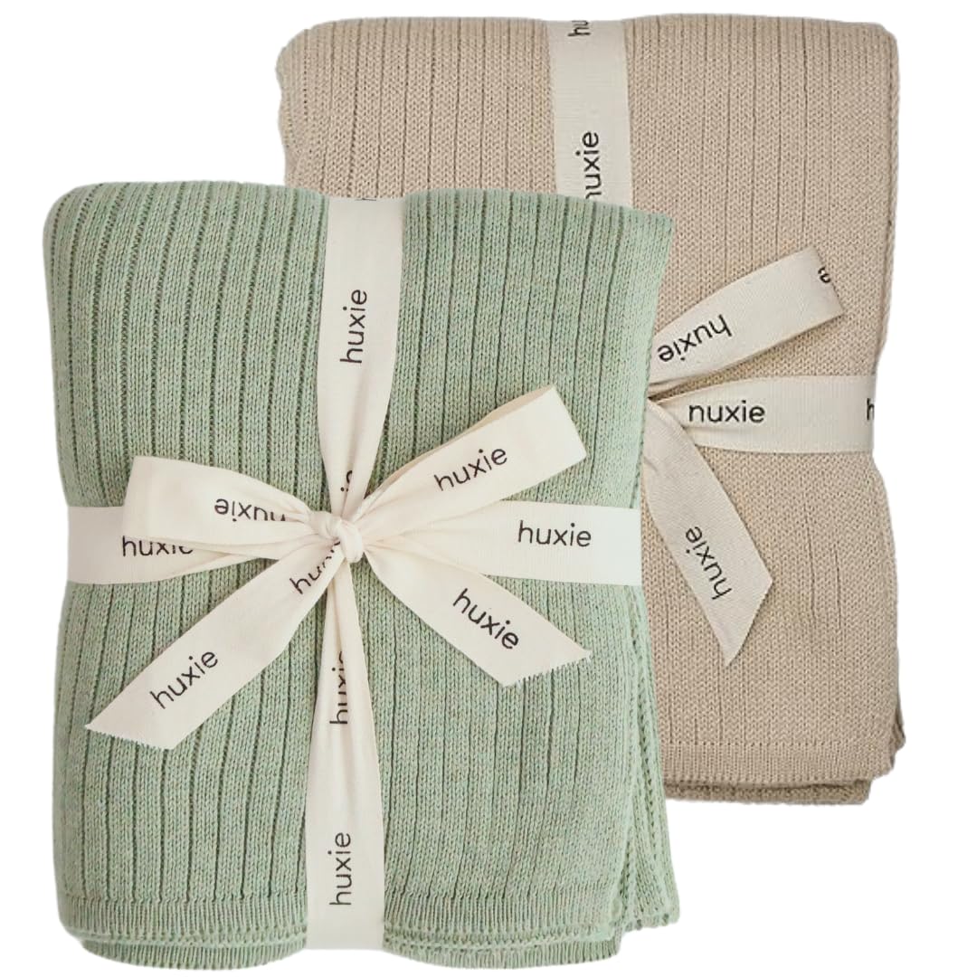 Huxie knitted baby blanket Fog colorway offers cozy organic warmth for sensitive skin.