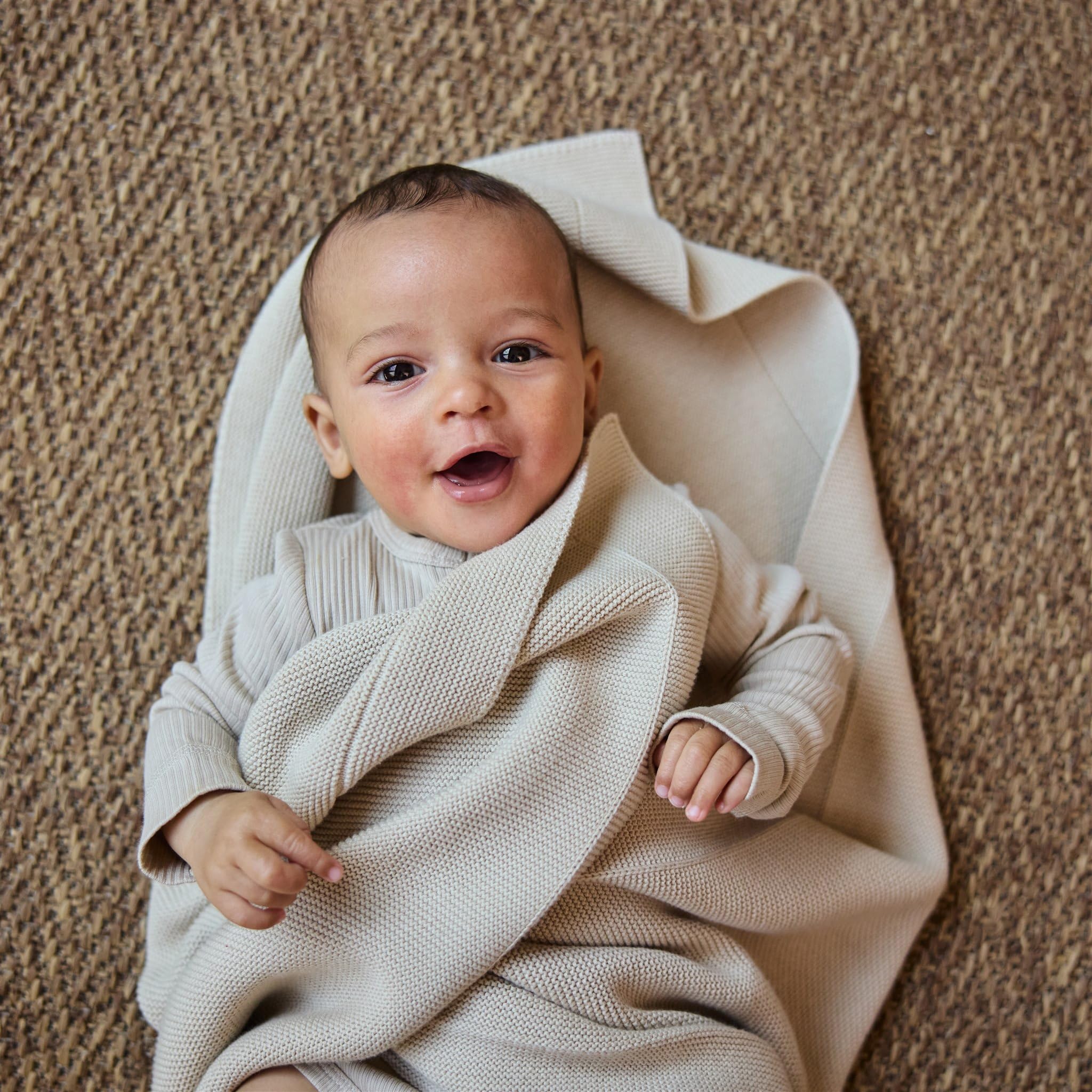 Huxie Fog baby blanket in crib-time cozy swaddle scene.