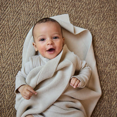 Huxie Fog baby blanket in crib-time cozy swaddle scene.