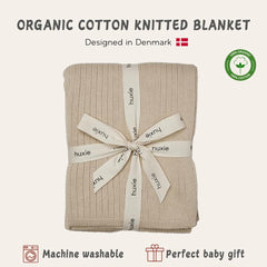Huxie knitted baby blanket fog swaddle-use scene demonstrates versatile newborn comfort.