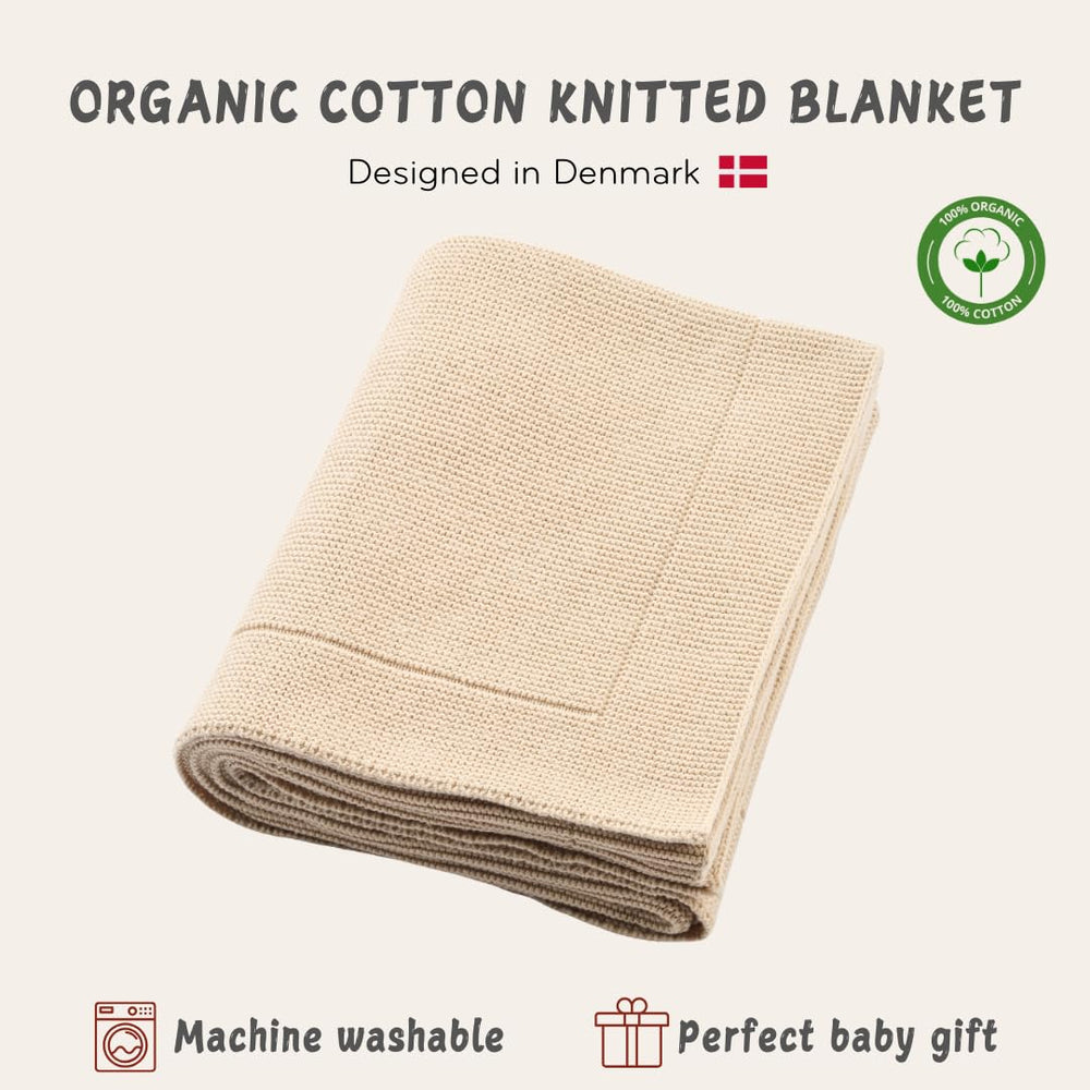 Huxie Fog blanket swaddle use showing snug newborn wrap.