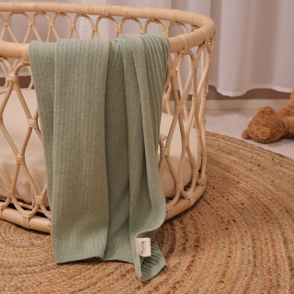 Huxie knitted baby blanket in stroller highlights light warmth during outings.