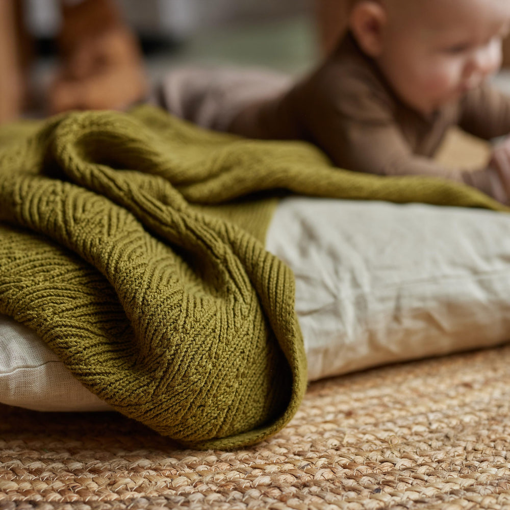 Huxie knitted baby blanket moss green gift-ready packaging signals timeless baby gift