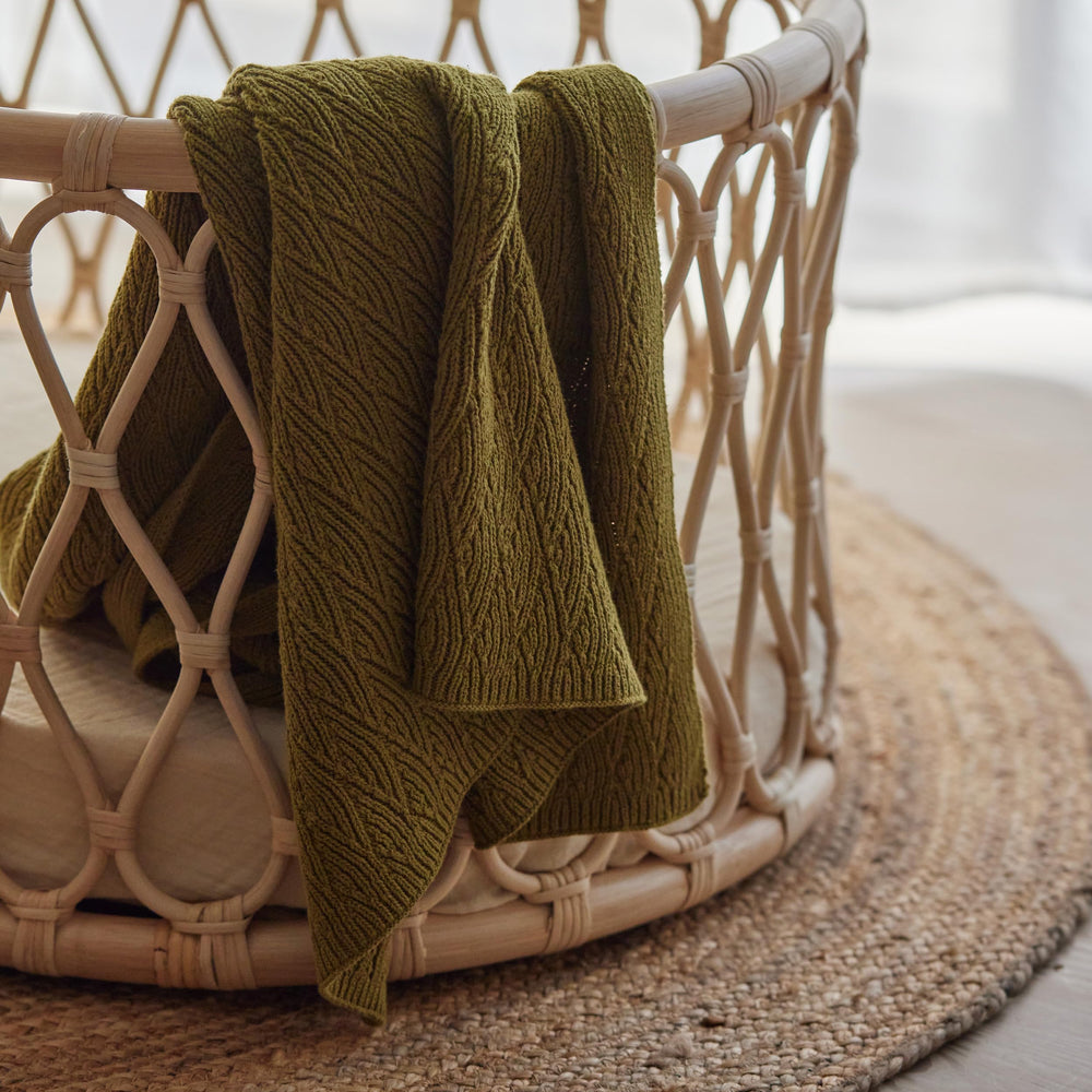 Huxie knitted baby blanket moss green after washing highlighting easy-care durability