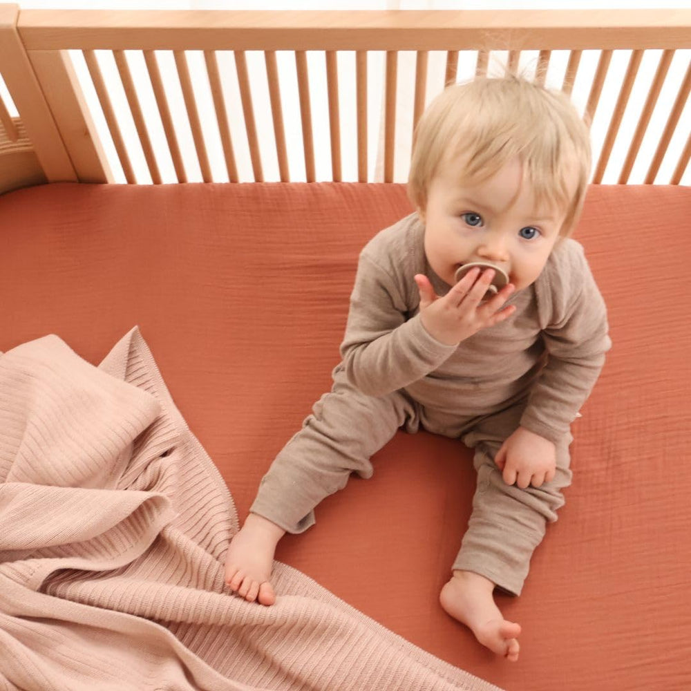 Huxie neutral blush tone complements any nursery decor.