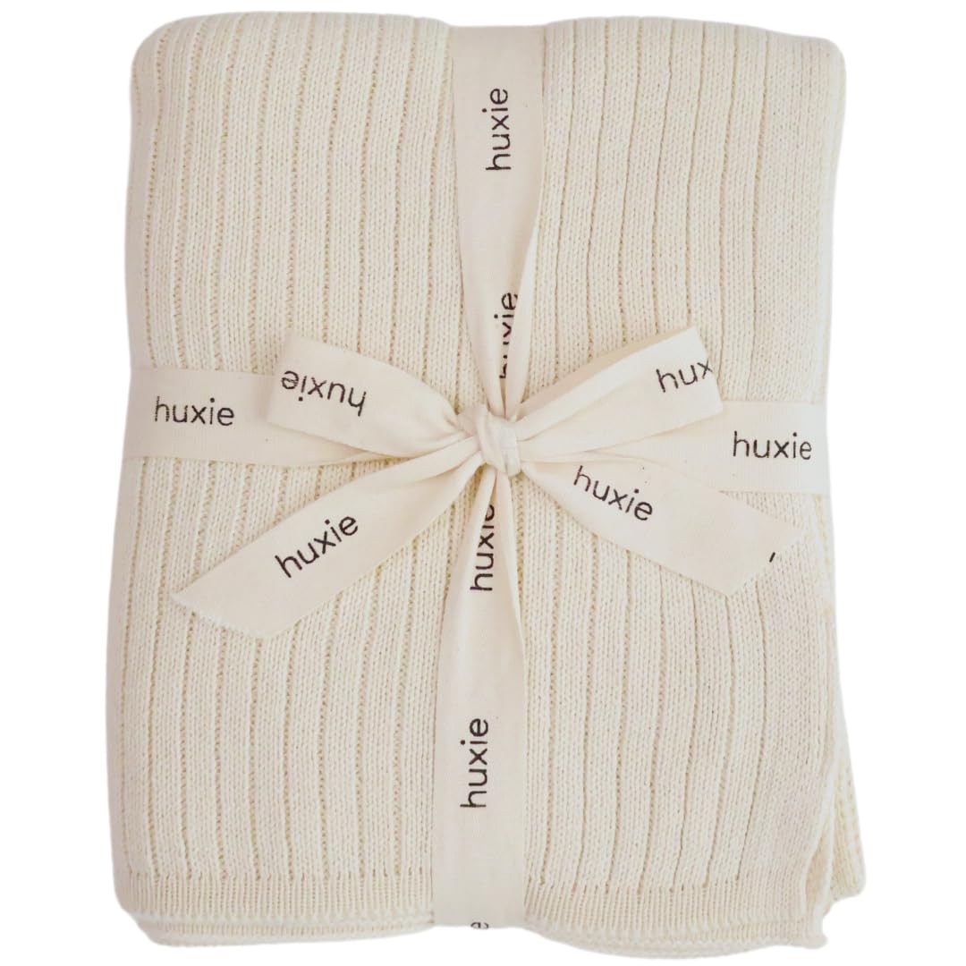 Huxie Knitted Baby Blanket soft white closeup shows plush organic cotton texture for sensitive skin