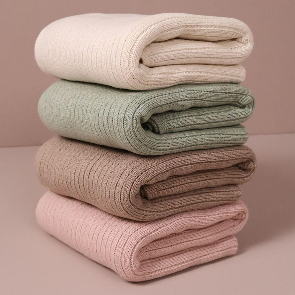 Huxie Knitted Baby Blanket soft white wrapped around baby for cozy coverage