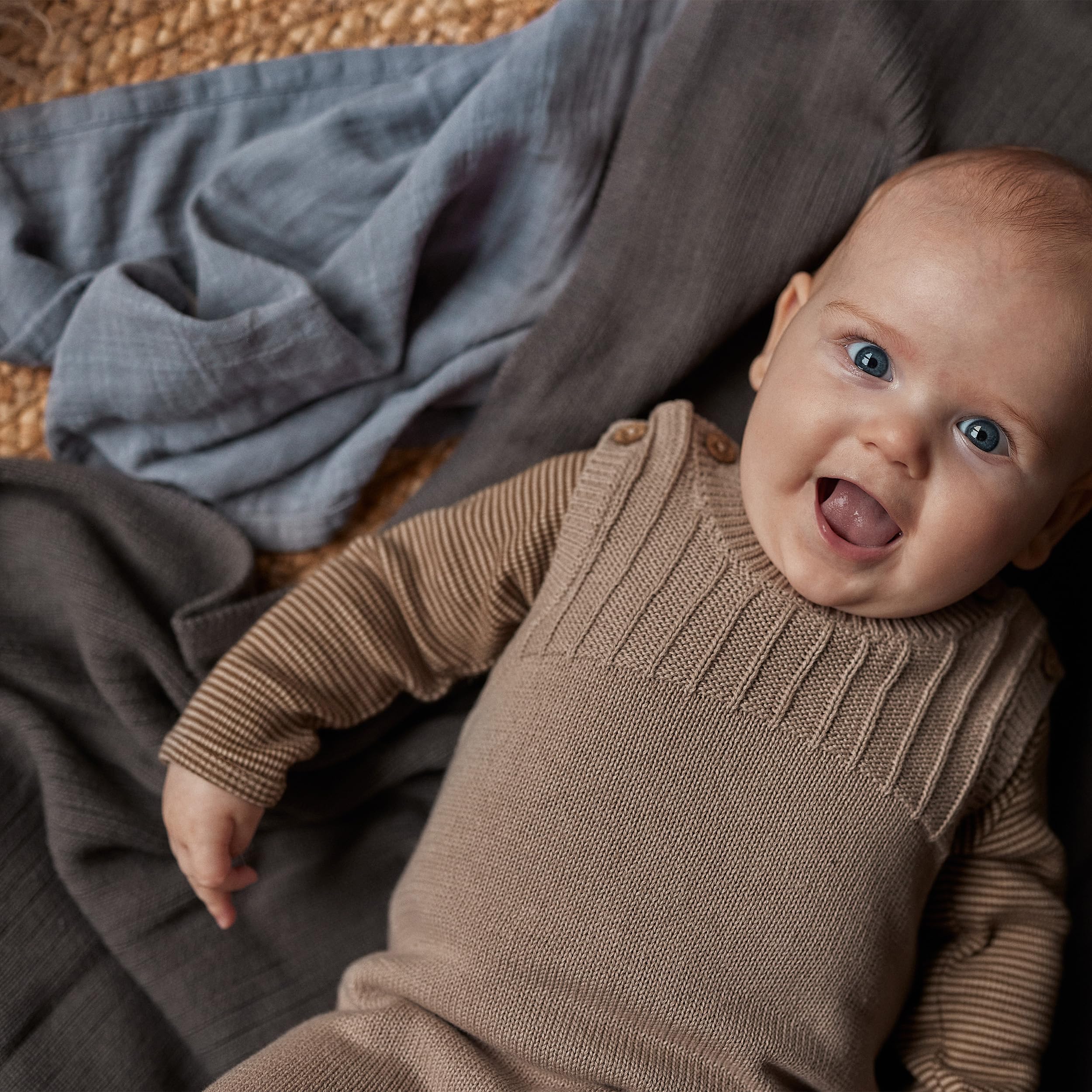 Huxie Knitted Baby Blanket folded neatly highlights durable, easy-care material.