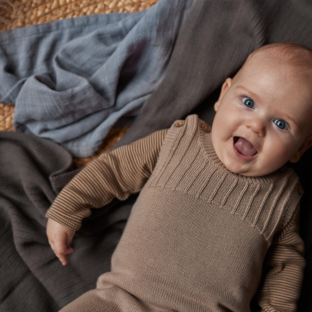 Huxie Knitted Baby Blanket folded neatly highlights durable, easy-care material.