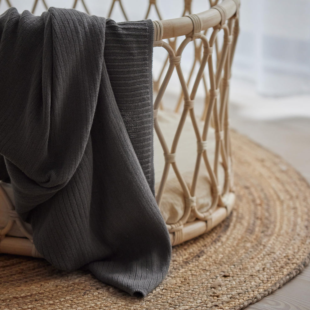 Huxie Knitted Baby Blanket in crib setup conveys safe, breathable comfort for naps.
