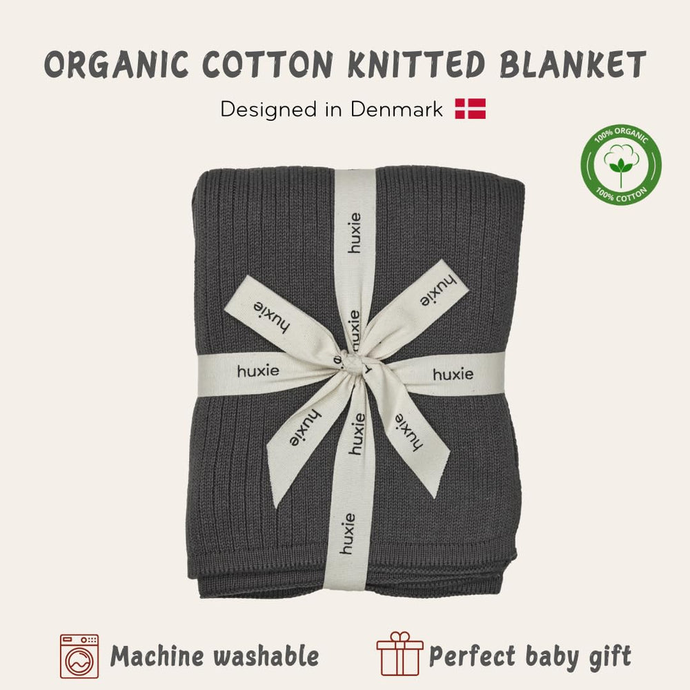 Huxie Knitted Baby Blanket newborn swaddle image emphasizes soft fibers and cozy wrap.