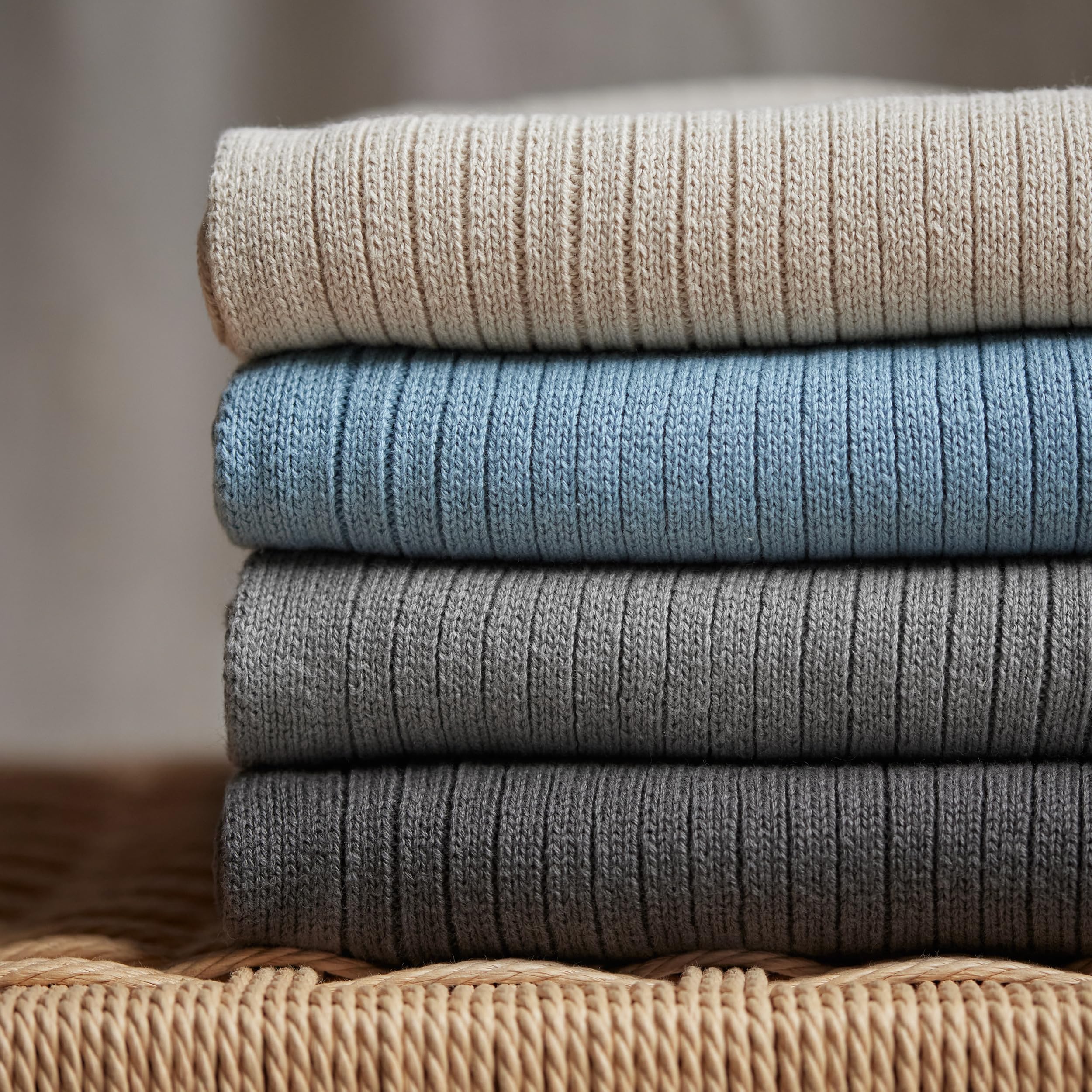 Huxie Knitted Baby Blanket care shot shows gentle washing and low-heat drying.