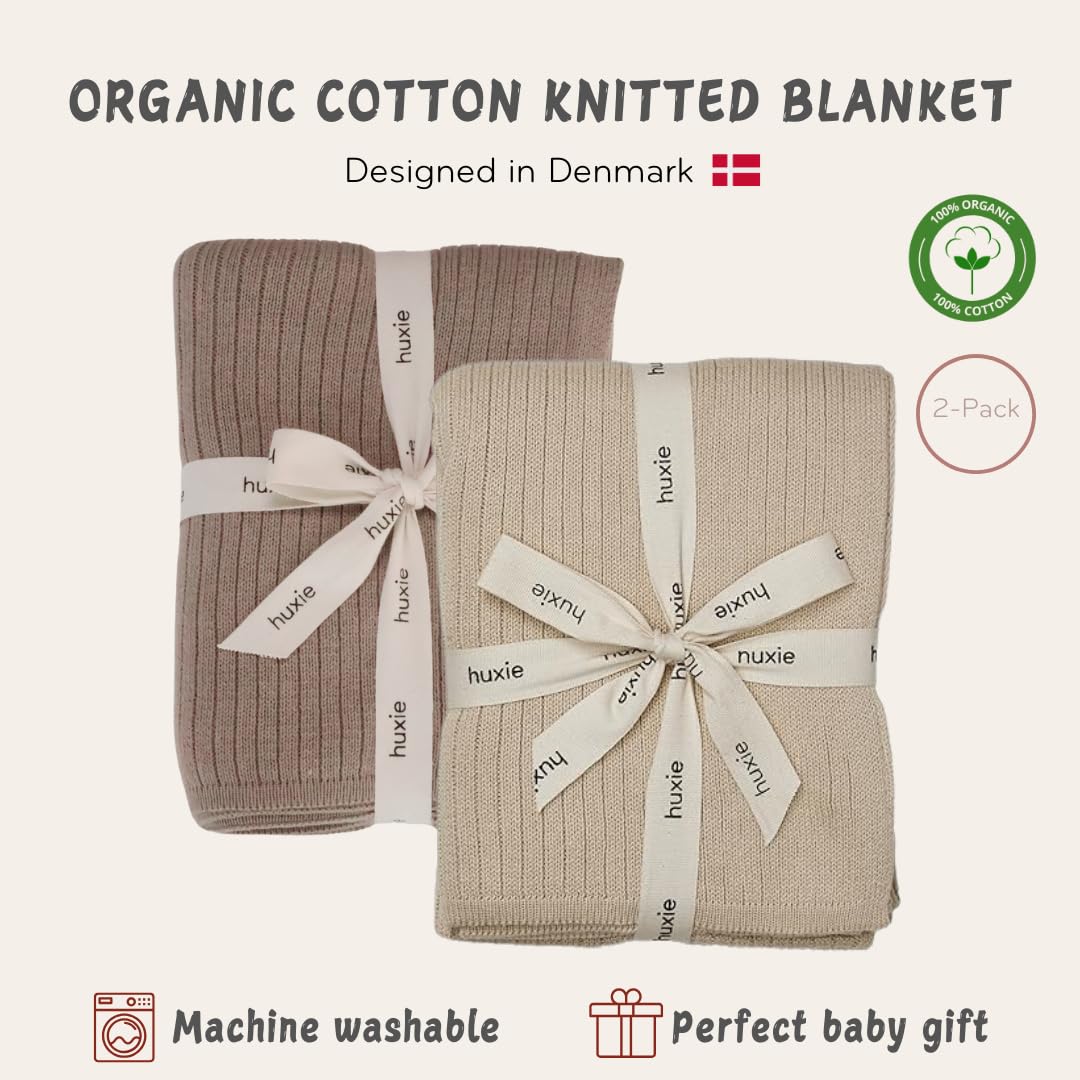 Huxie knitted baby blanket in stroller scene highlights breathable organic cotton.