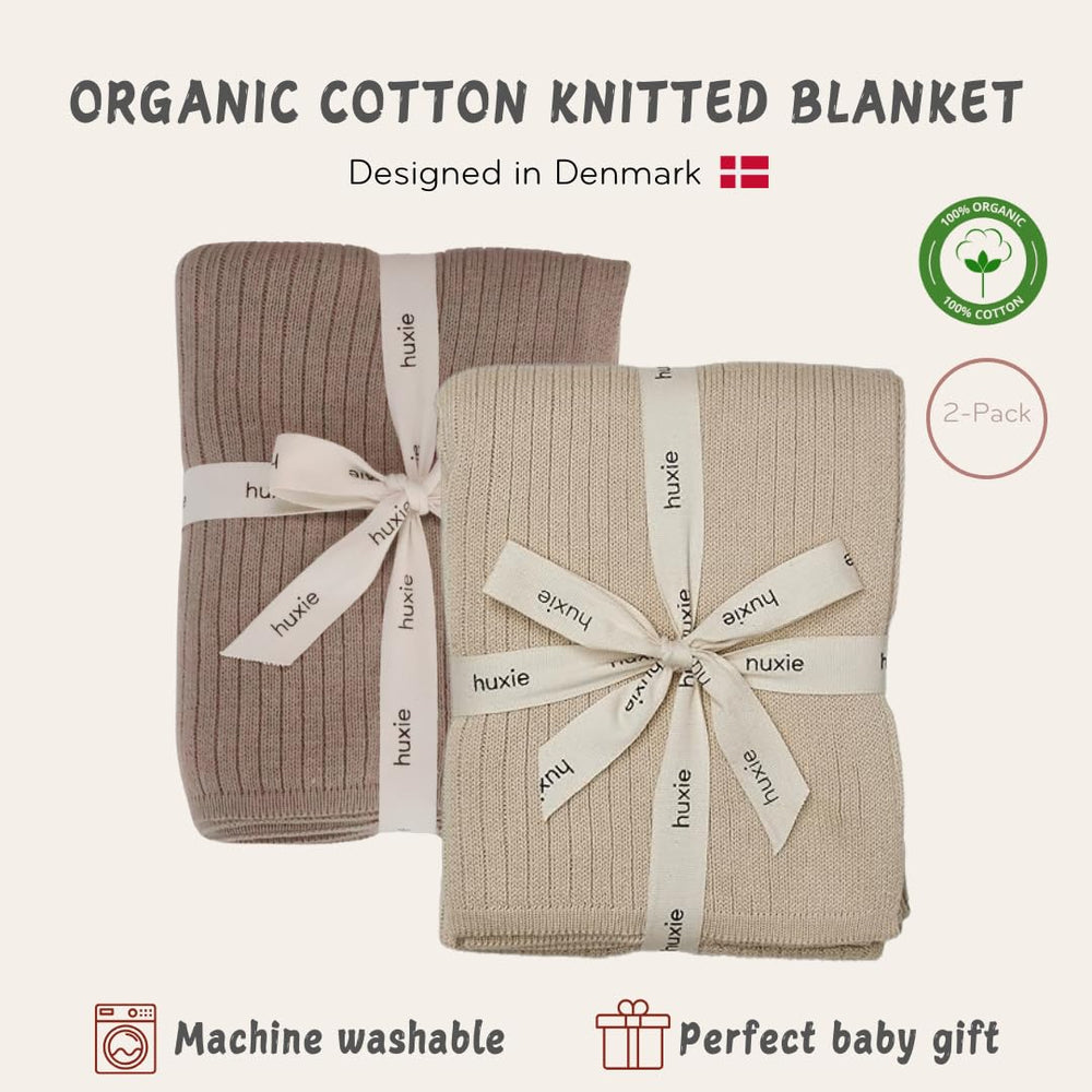 Huxie knitted baby blanket in stroller scene highlights breathable organic cotton.