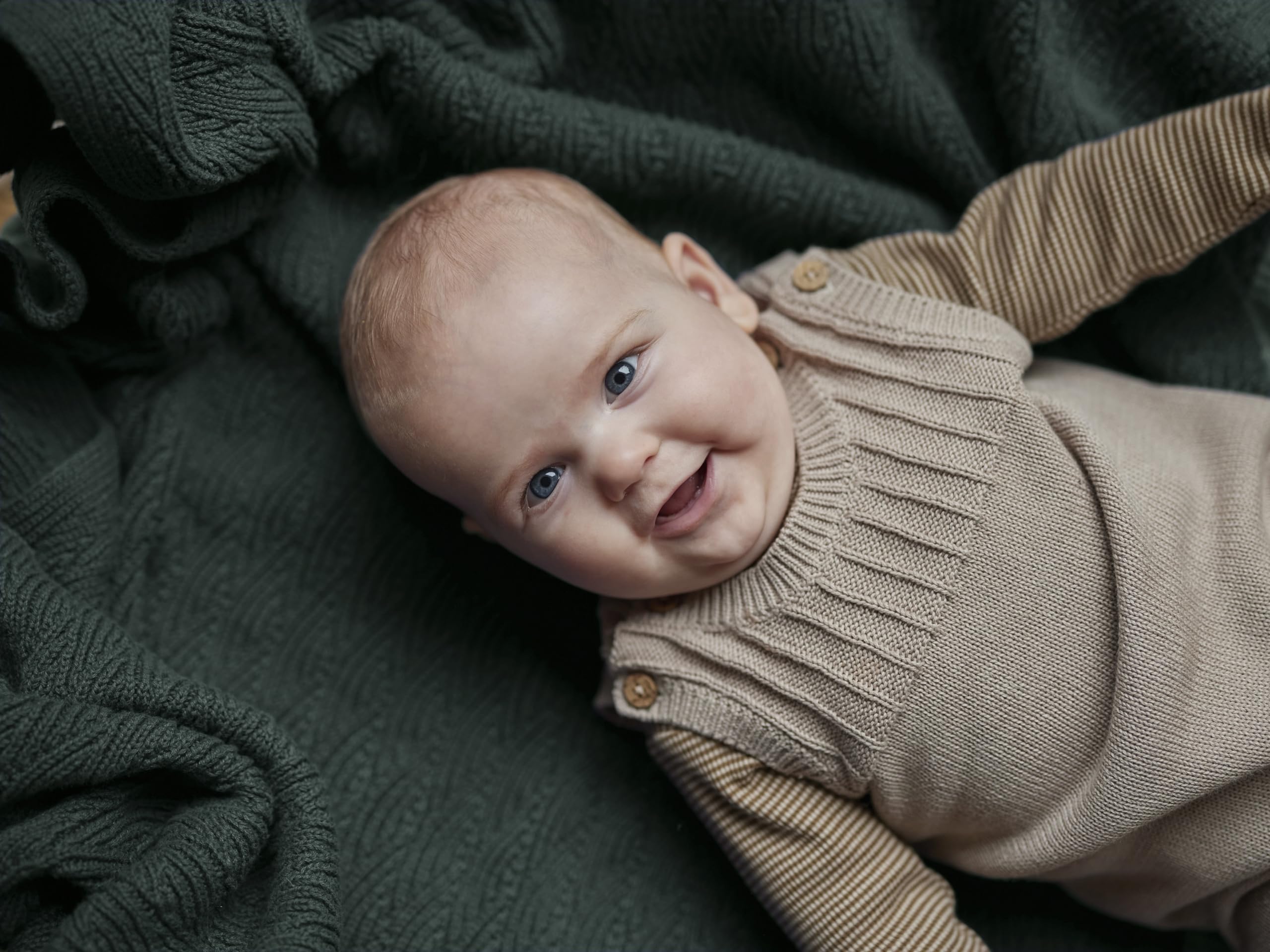 Huxie Knitted Baby Blanket swaddle setup demonstrates secure newborn wrapping