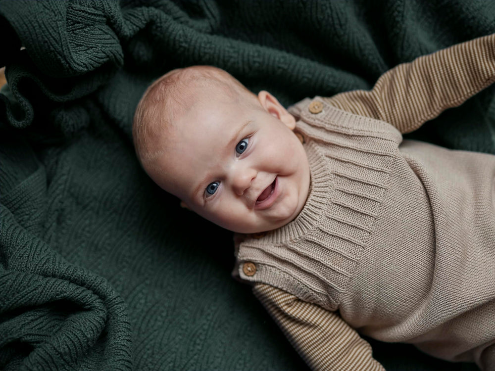 Huxie Knitted Baby Blanket swaddle setup demonstrates secure newborn wrapping