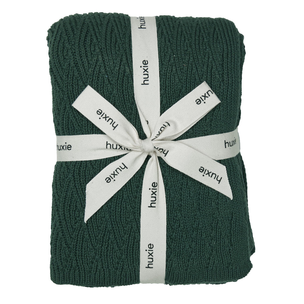 Huxie Knitted Baby Blanket texture close-up shows plush organic cotton softness