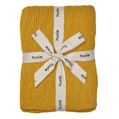 Huxie Waves Yellow knitted blanket closeup showing ultra-soft organic cotton for delicate skin