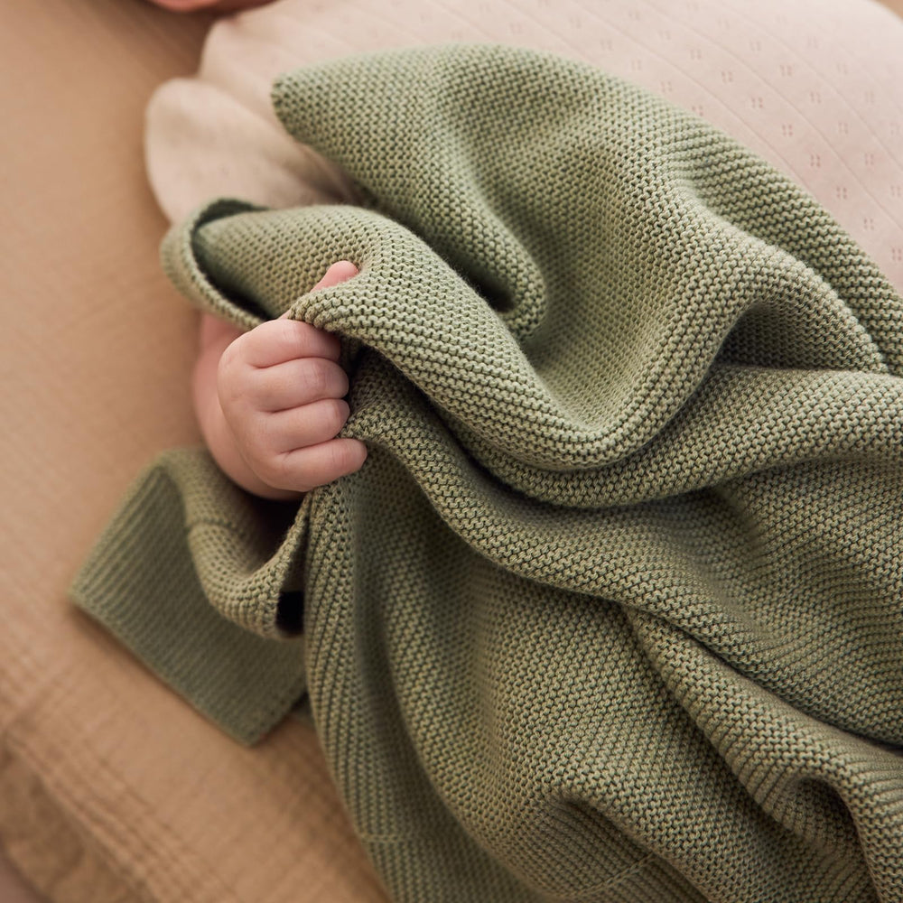Huxie roman green blanket showcased as premium gift option at baby showers.