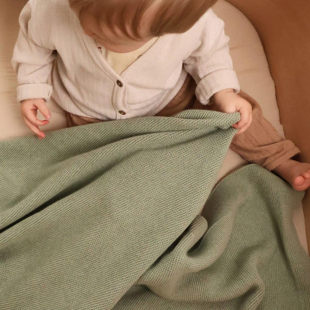 Huxie knitted blanket folded compactly for easy storage and travel.