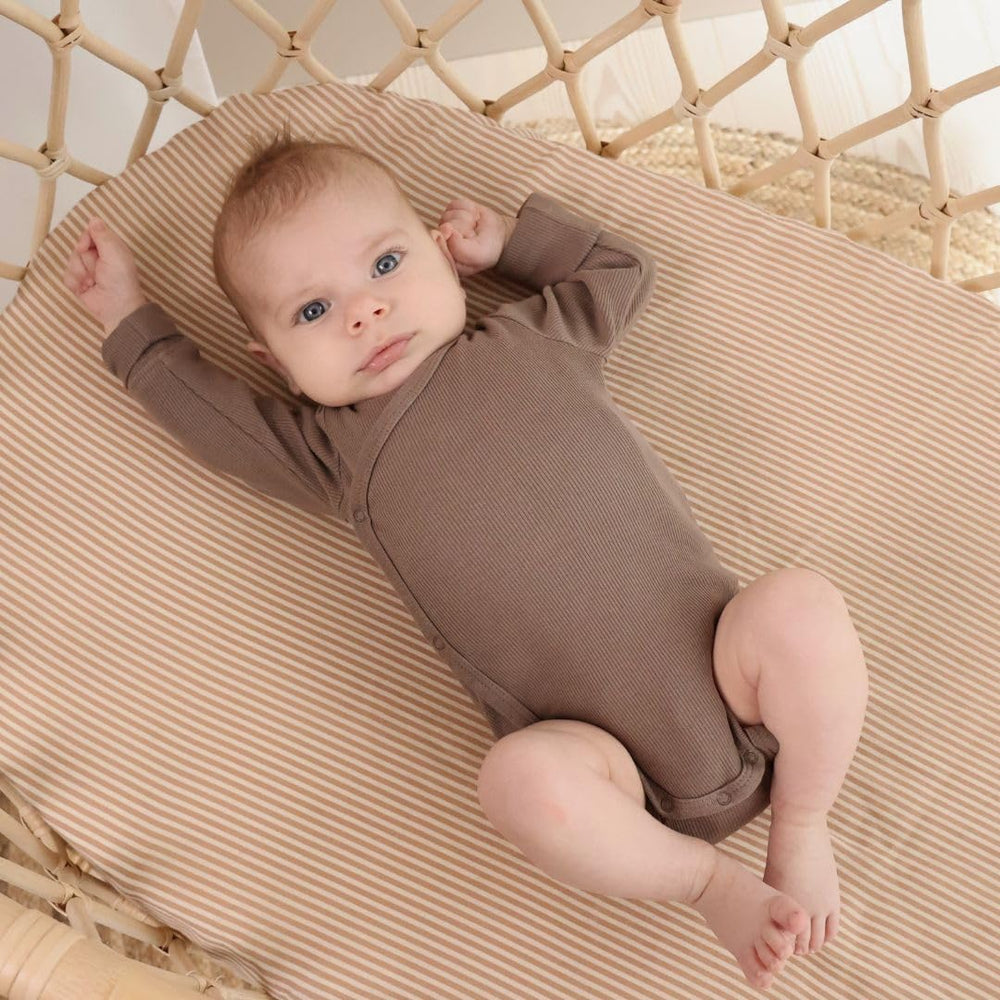 Huxie mini crib sheet 24x38 fit highlights deep pockets and elastic edge for a secure, snug fit.