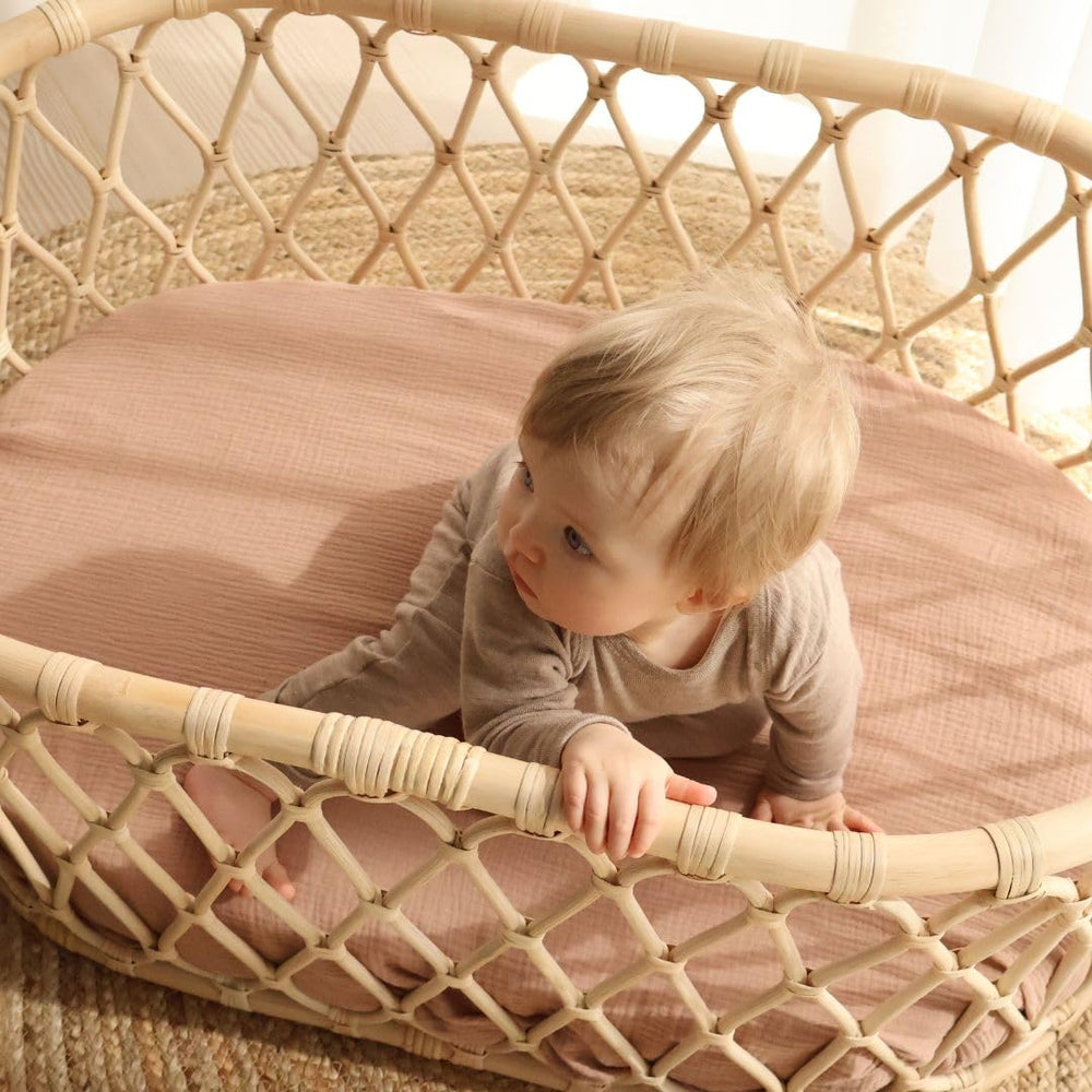Huxie mini crib sheet on Pack and Play demonstrates secure fit for travel