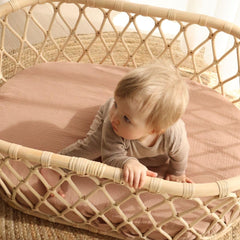 Huxie mini crib sheet on Pack and Play demonstrates secure fit for travel