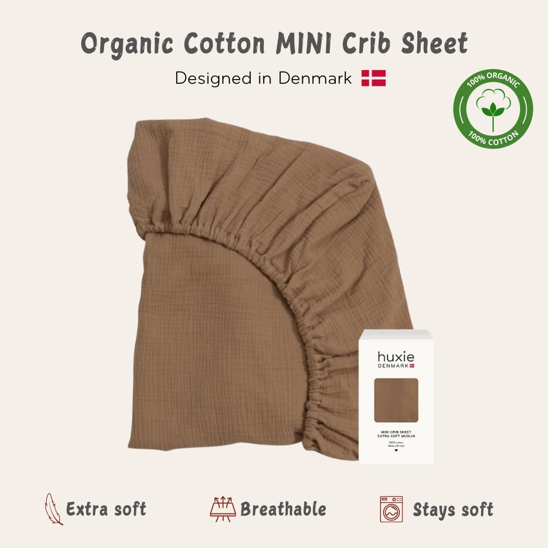 Huxie natural color mini crib sheet on baby bed shows gender-neutral design