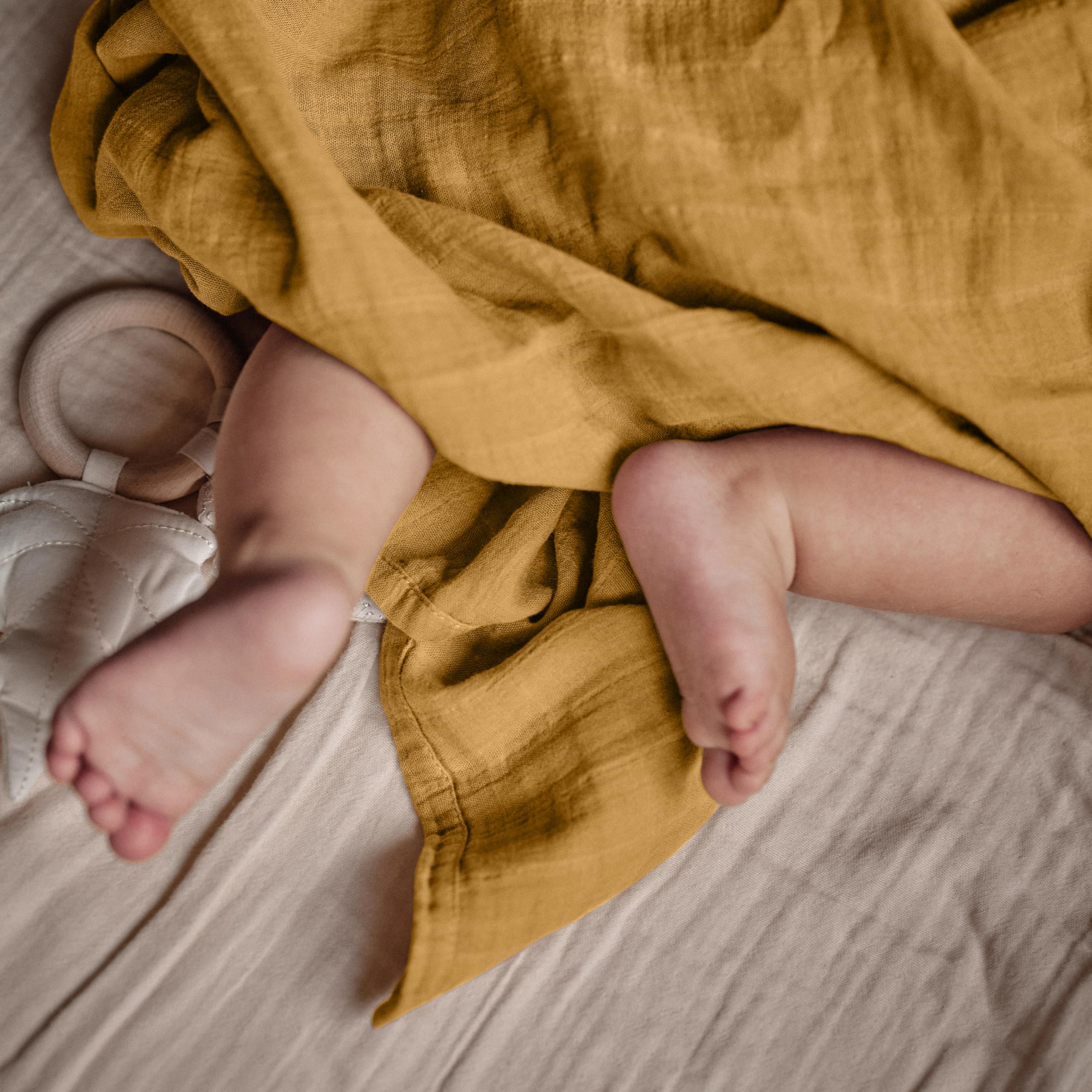 Huxie Swaddle Autumn Yellow receiving blanket use in a cuddle moment