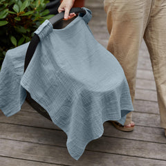 Huxie Tradewinds organic fabric shown as nursing cover for discreet feeding.