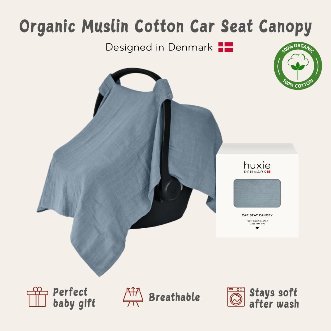 Huxie Tradewinds breathable muslin canopy protecting baby from sun and wind.