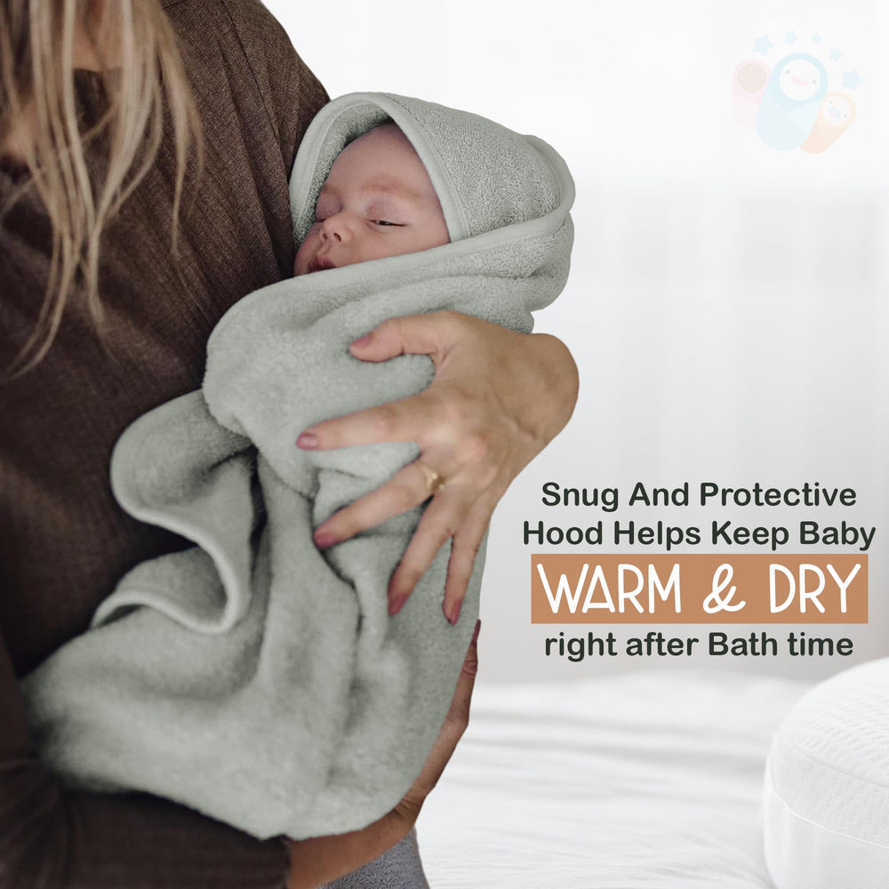 Infancie moss green towel on baby for soft, warm drying.