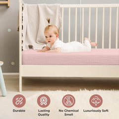 Infancie muslin crib sheets peach ivory colors on crib illustrate neutral nursery styling
