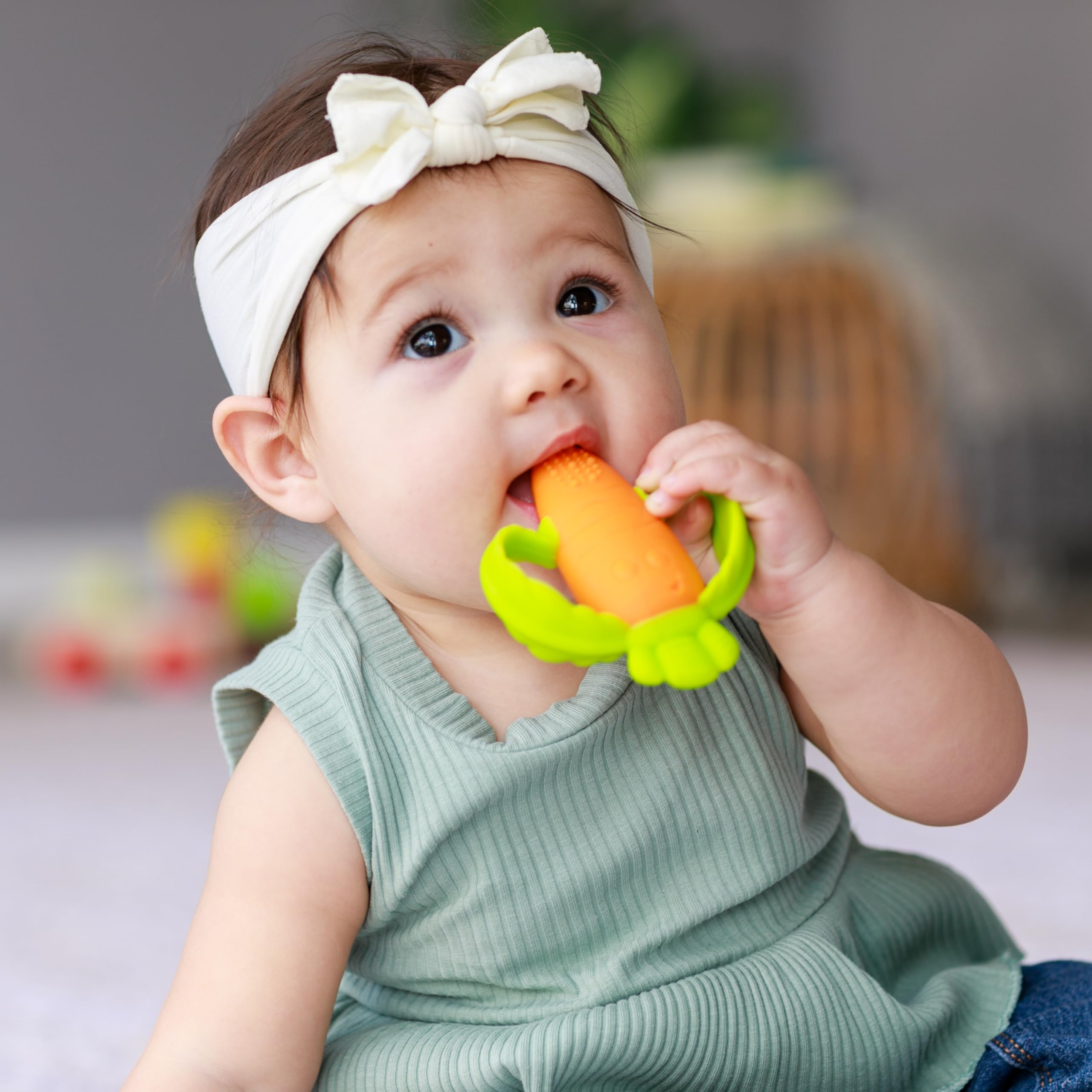 Infantino Lil’ Nibbles teether bright orange color stands out in bag.