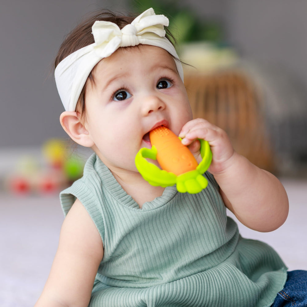 Infantino Lil’ Nibbles teether bright orange color stands out in bag.