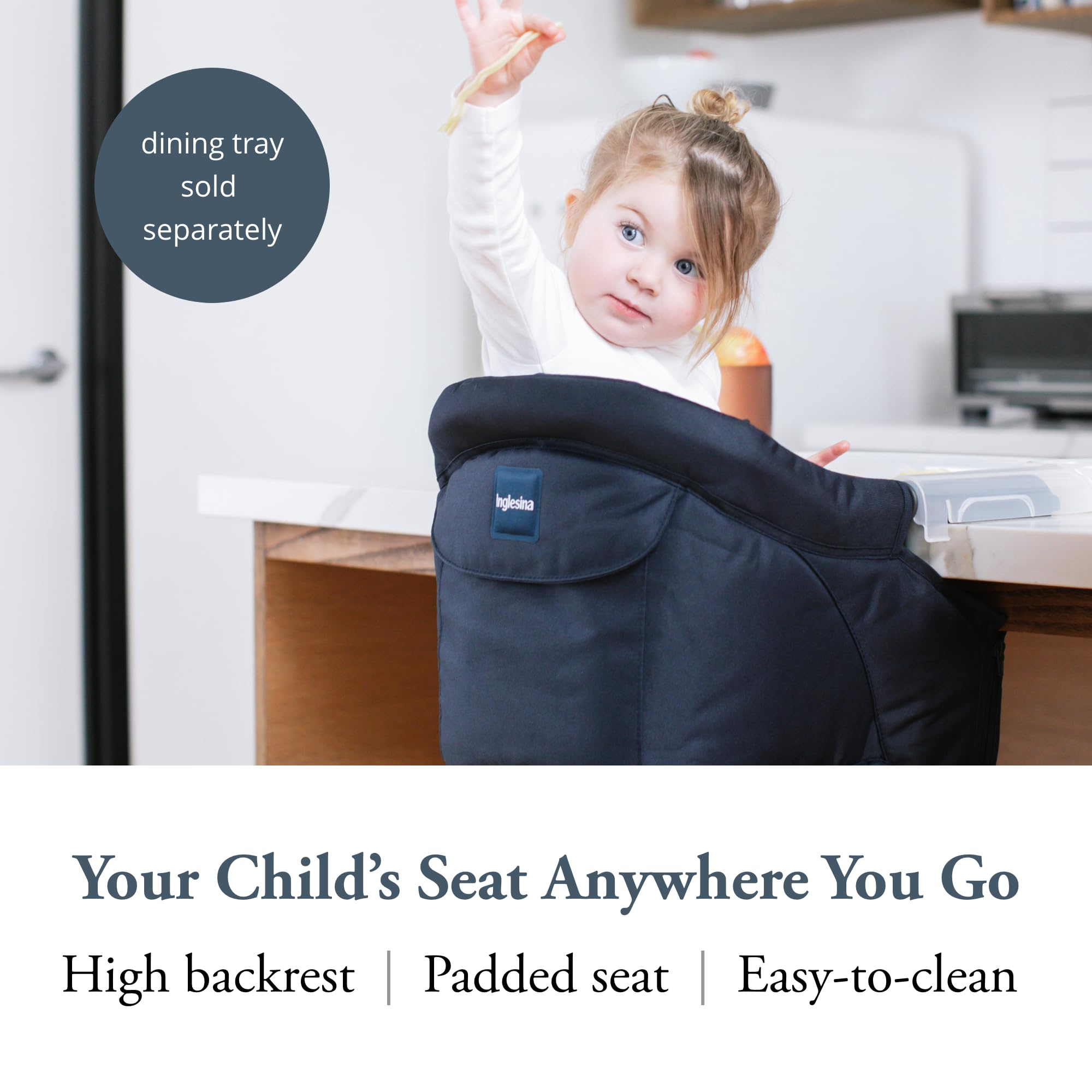 Inglesina Fast Table Chair Navy attached to a table for stable child seating.
