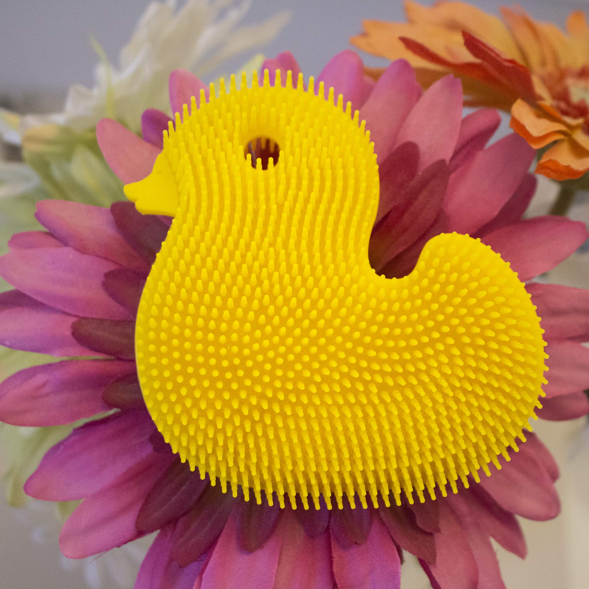 Innobaby Silicone Duck Scrub soft strands provide gentle massage on sore areas.