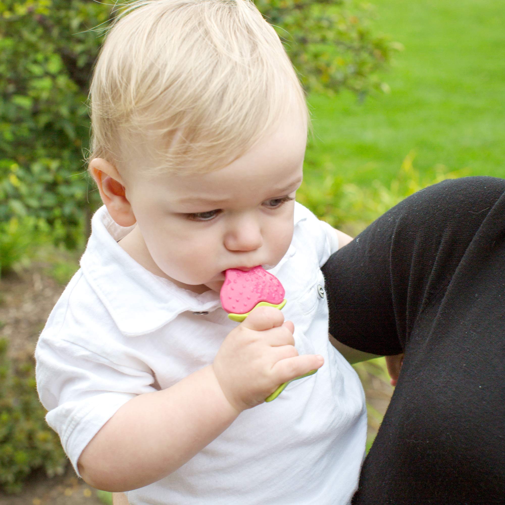 Innobaby Teethin Apple teether shown in mouth for front and back teething relief.