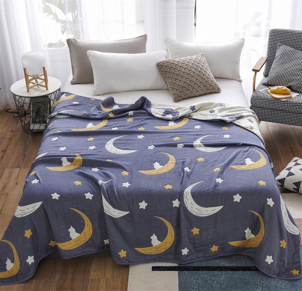 J-pinno Bright Moon Stars blanket on bed for breathable all-season warmth.