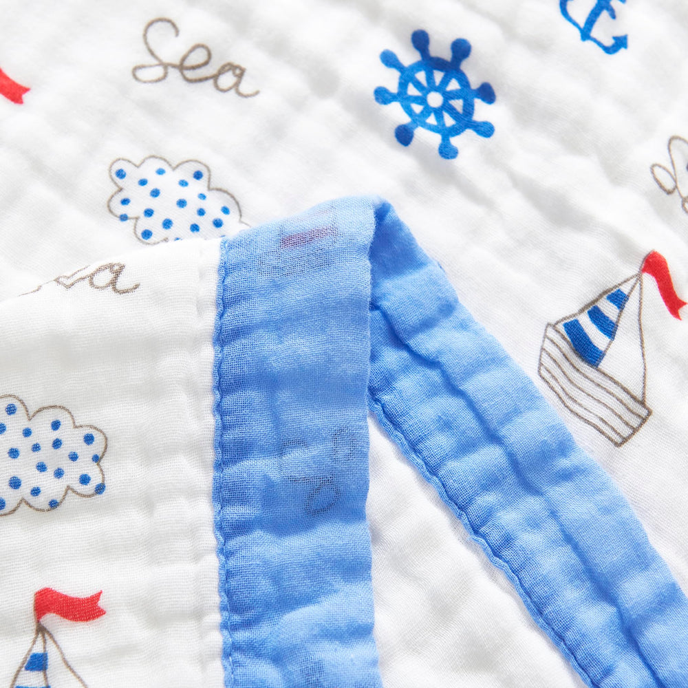 Nursery scene with J-pinno Sailboat blanket as a nap cover