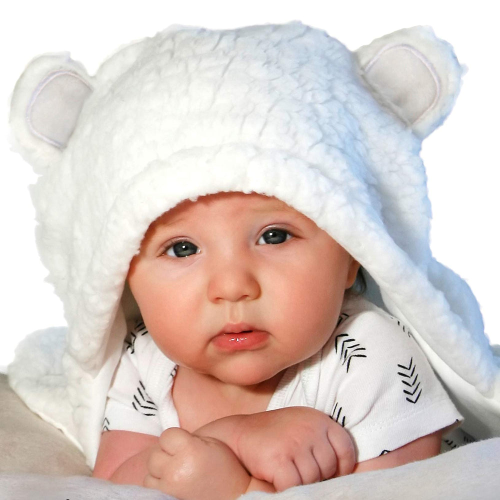 Jam Naturals baby swaddle blanket white on baby arms demonstrates secure gentle wrapping for newborn comfort