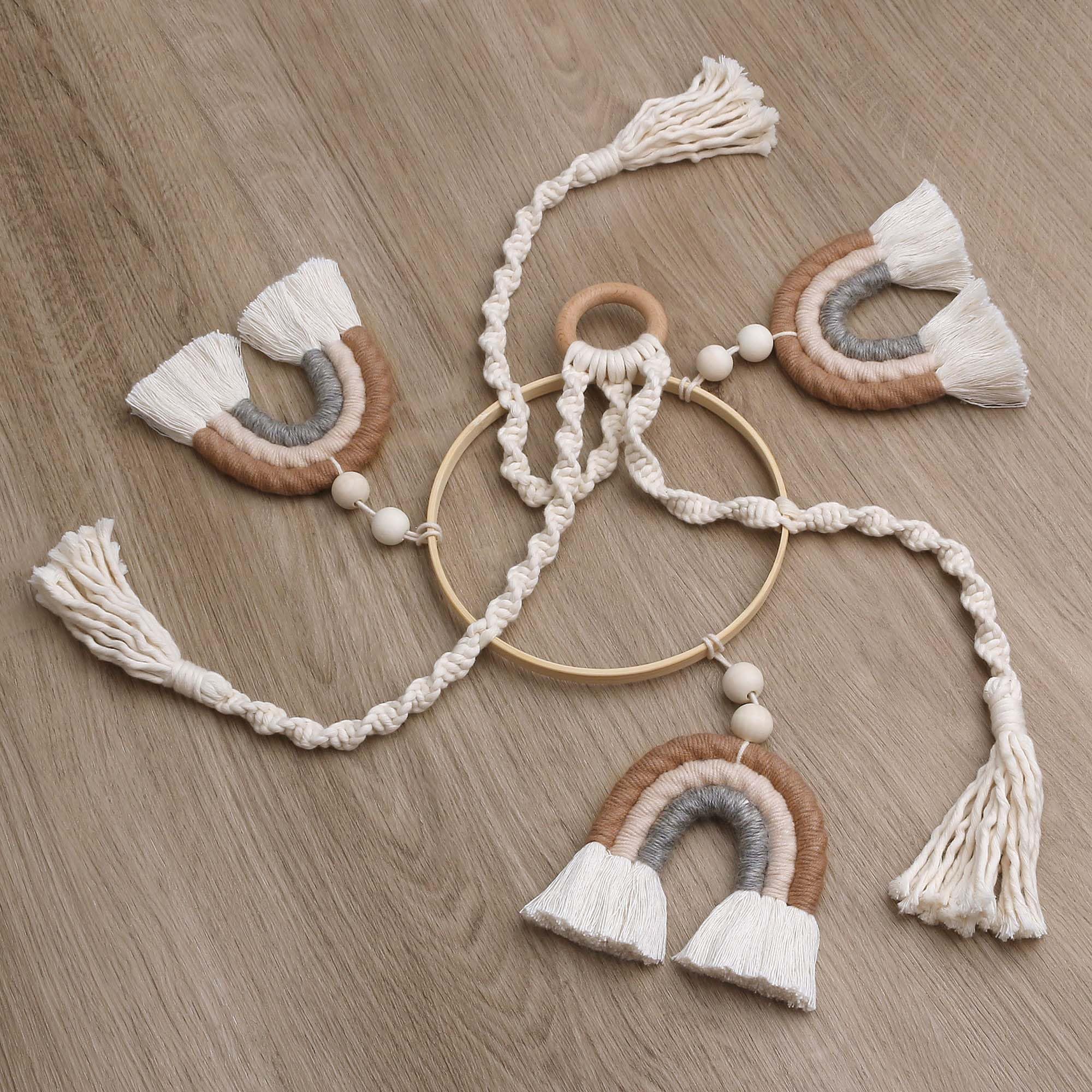 JILPAK macrame rainbow mobile on wooden hoop offers tactile textures for baby observation.