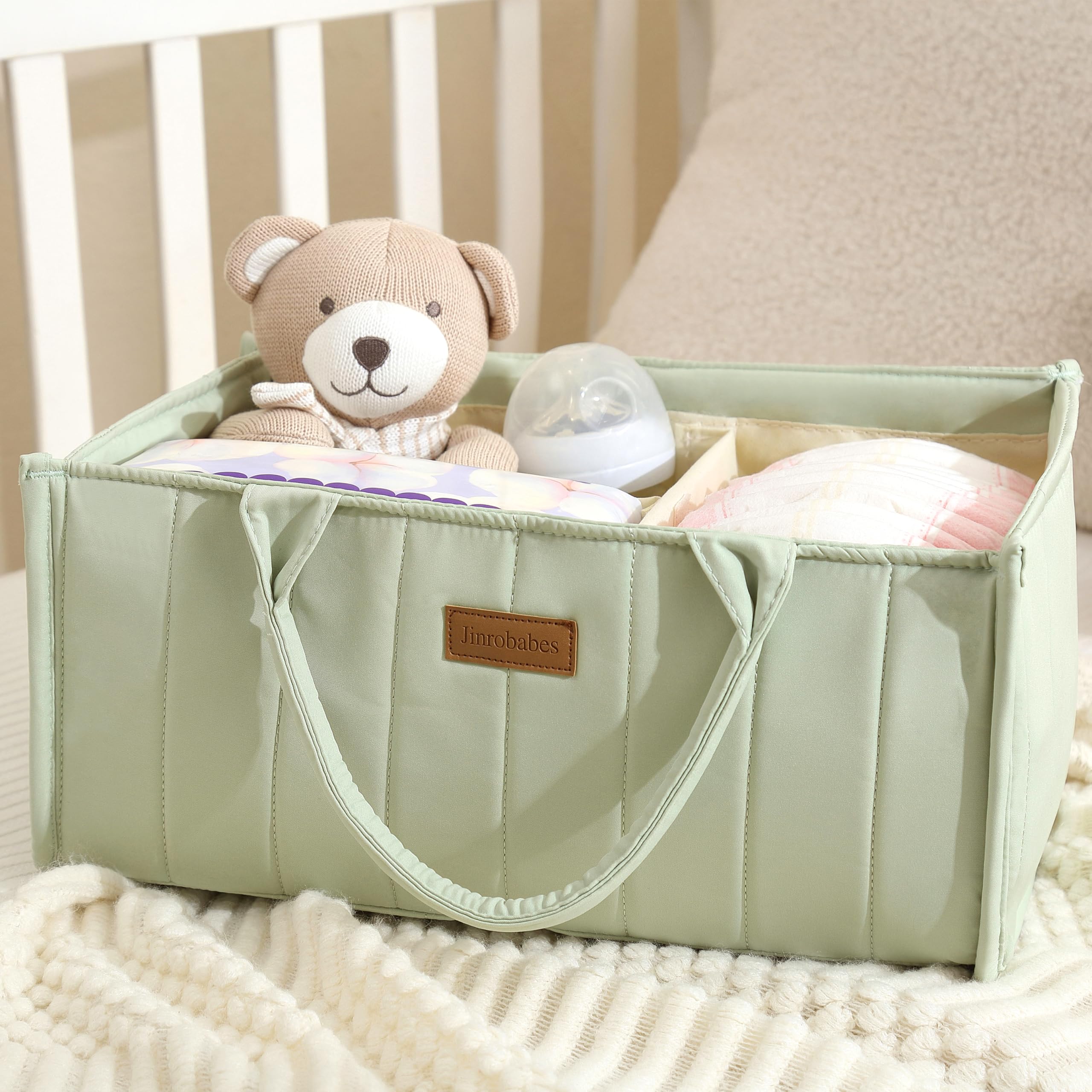 Jinrobabes diaper caddy filled with mom and baby necessities for a tidy changing corner.