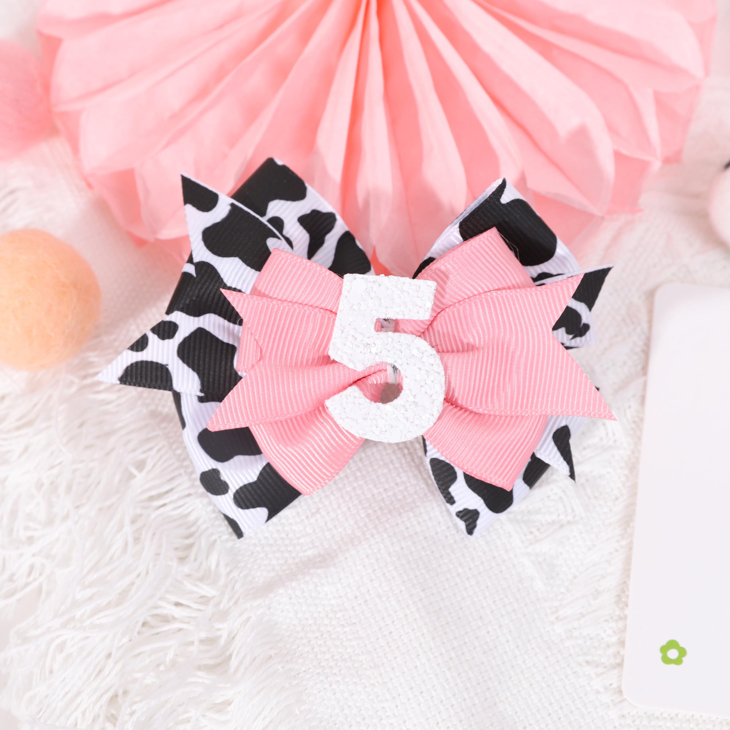 Jissoo cow print bow headband at farm-themed party, versatile decor and accessory.
